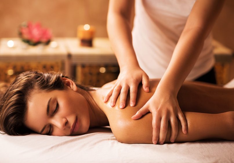 Young woman enjoying in back massage at the spa.